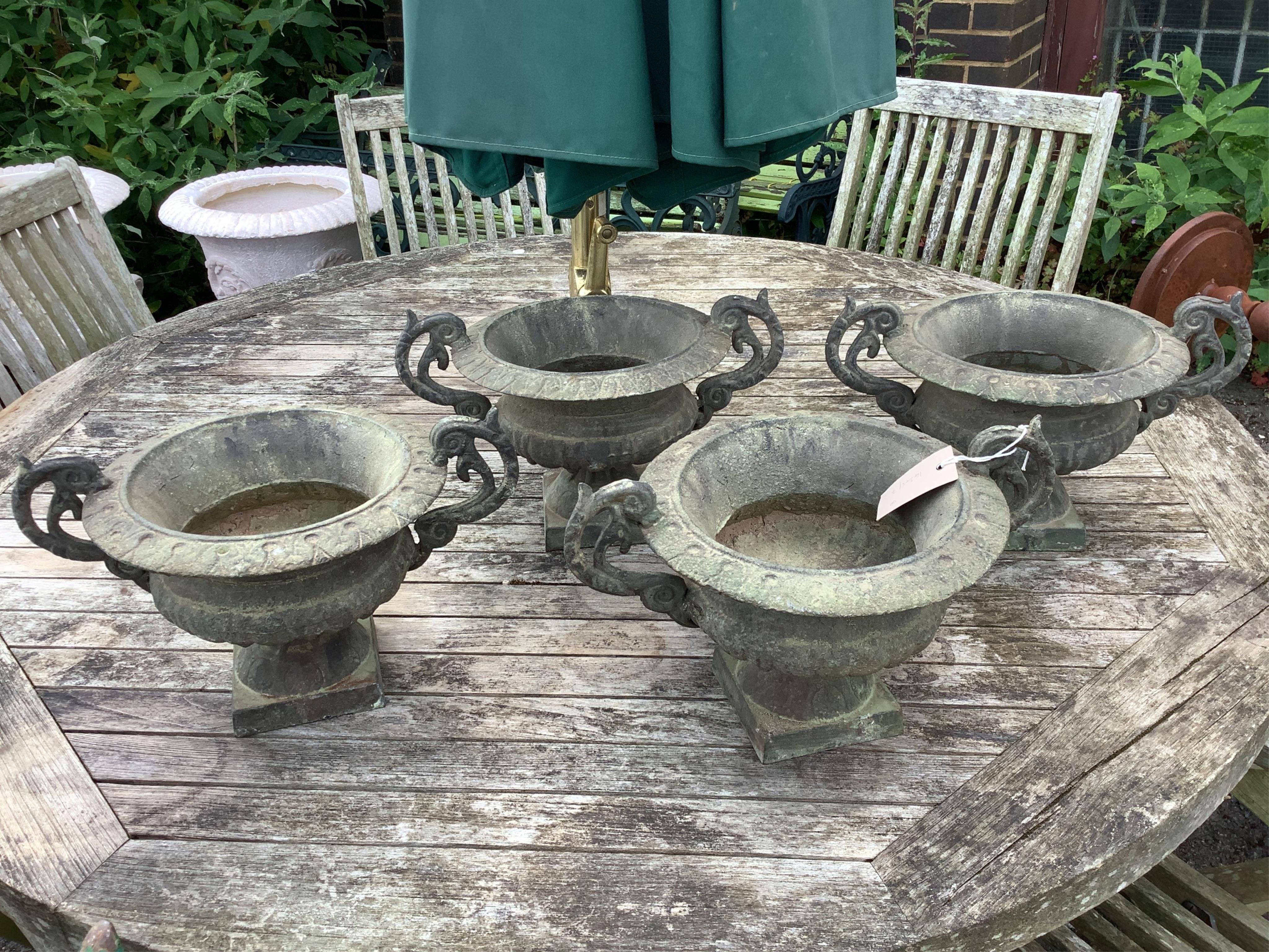 Four Victorian style cast iron campana garden planters, width 38cm, height 23cm. Condition - good